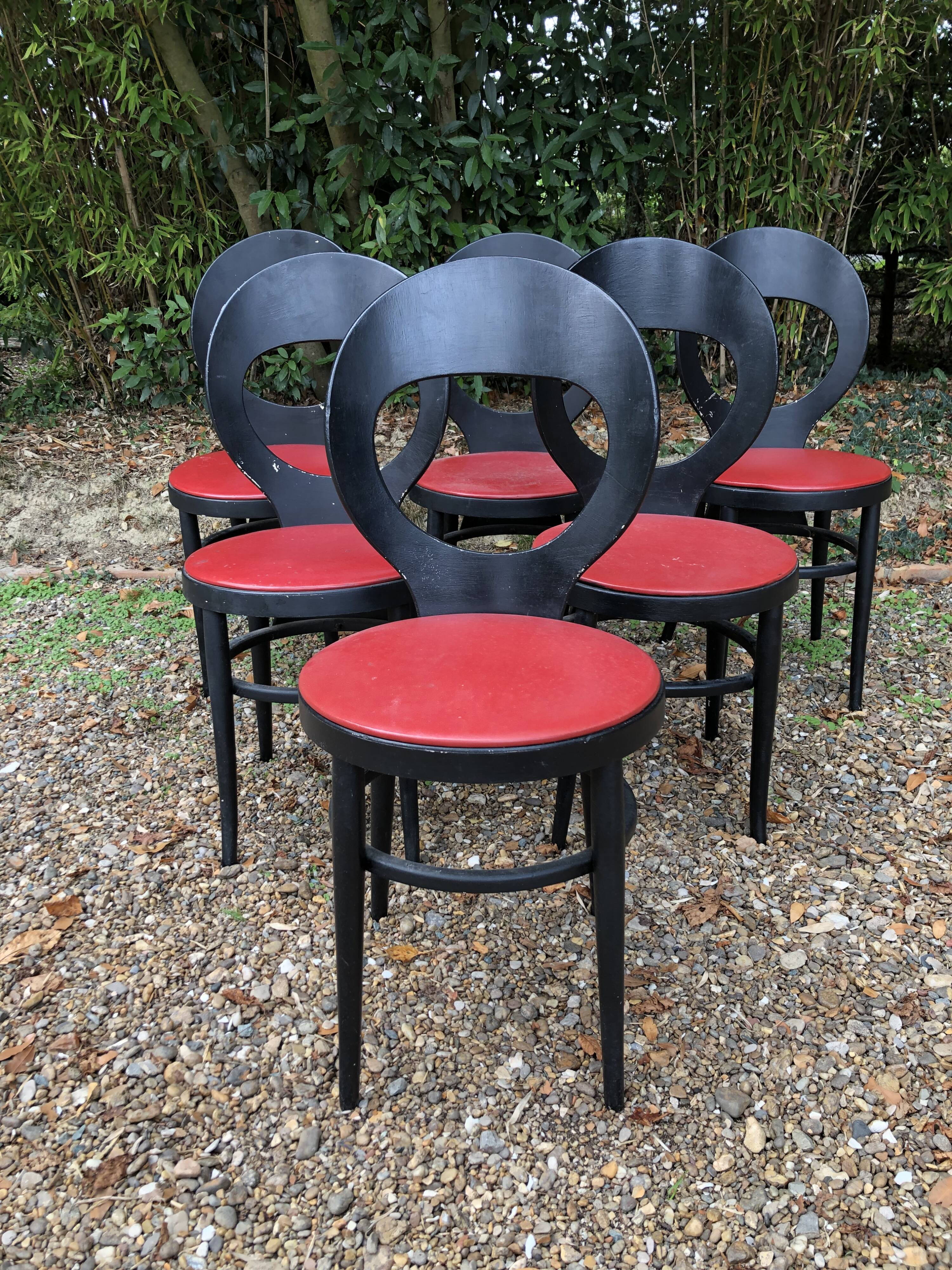 6 vintage Baumann seagull model chairs, black lacquered with red Skai seats.