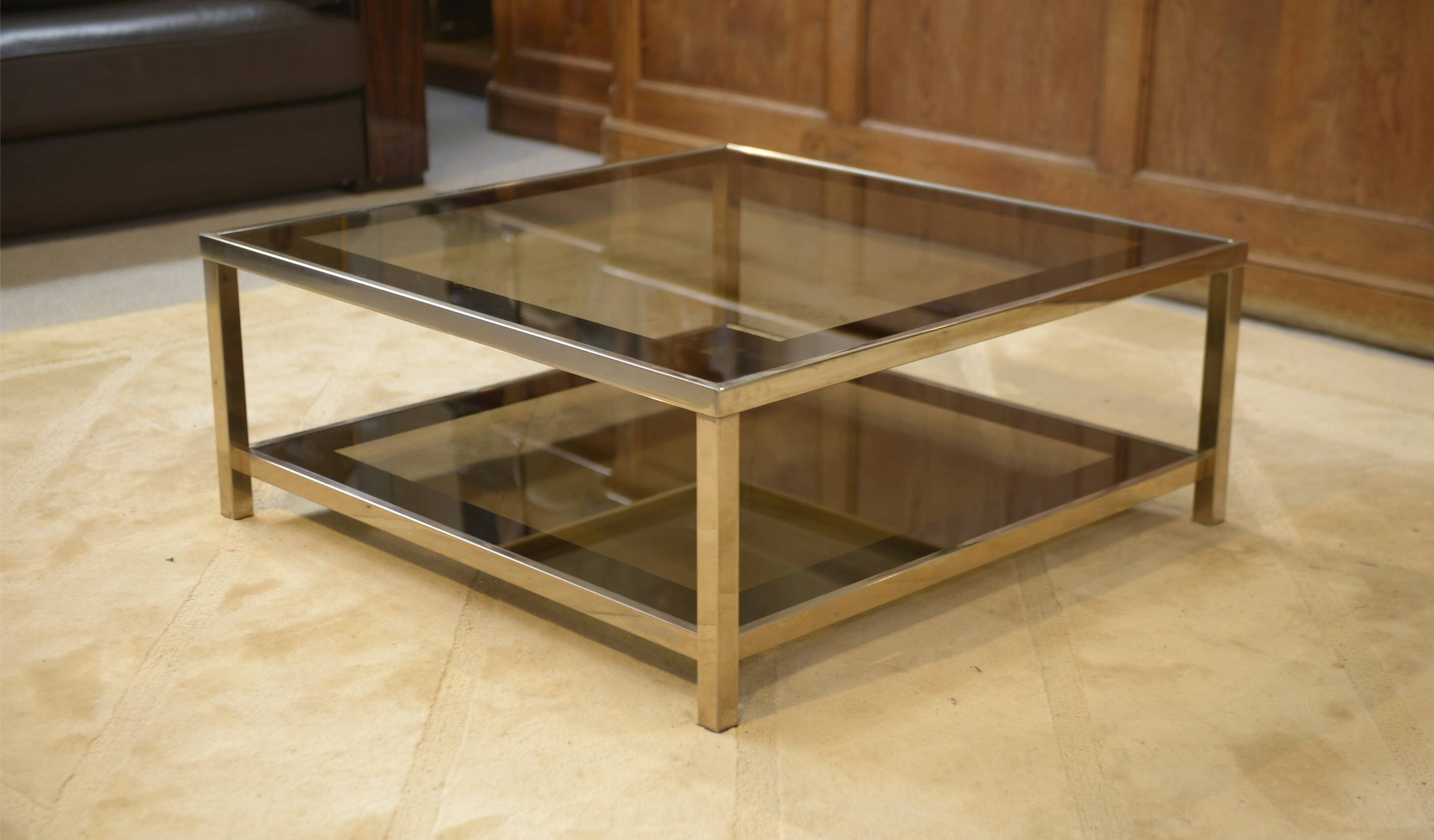 Hollywood Regency coffee table in smoked glass with mirrored framing from the 1970s.
