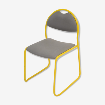 Yellow metal chair and grey skai