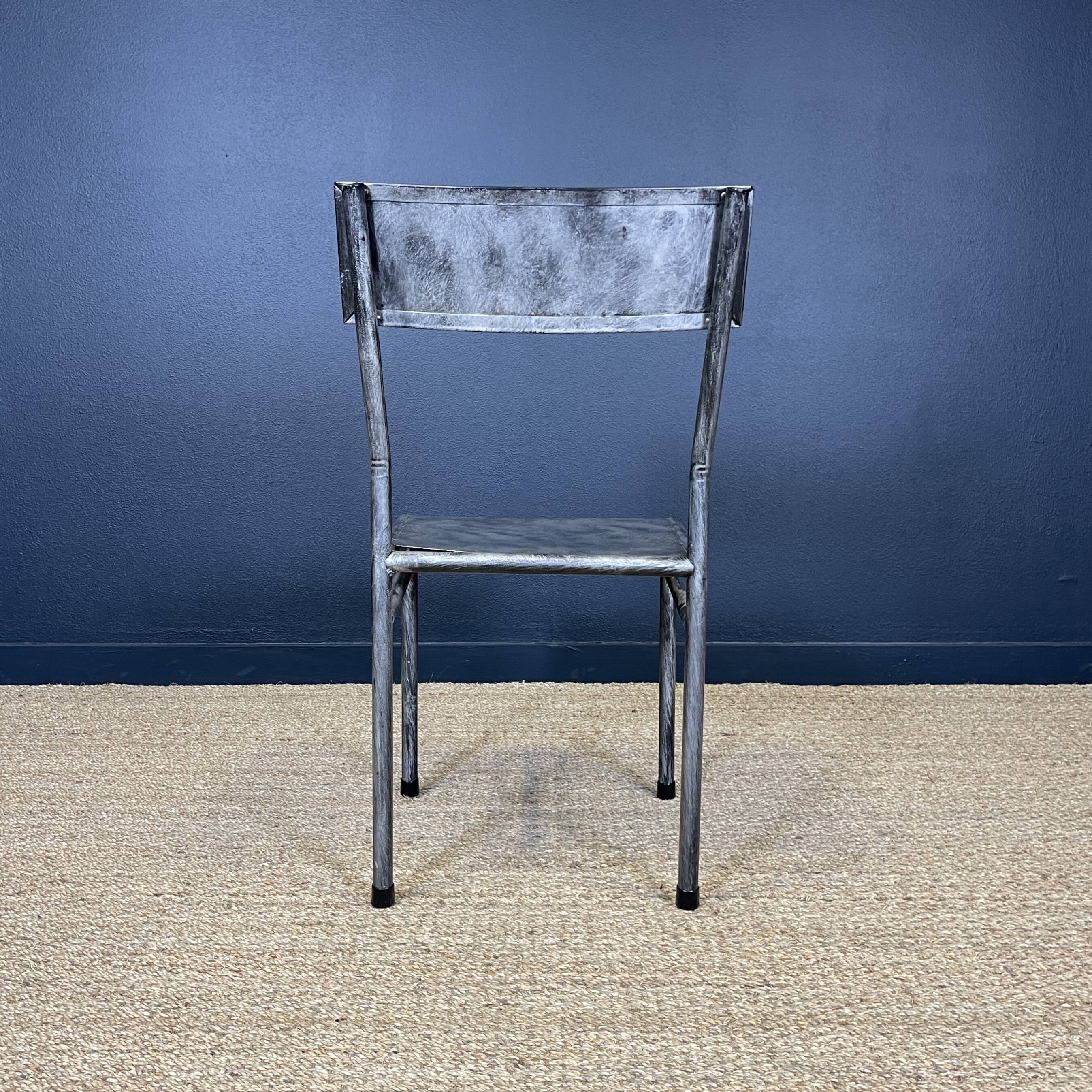 Pair of gray metal industrial chairs