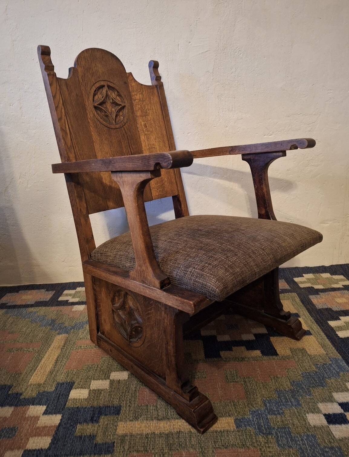Antique Gothic Revival carved oak armchair, 1910