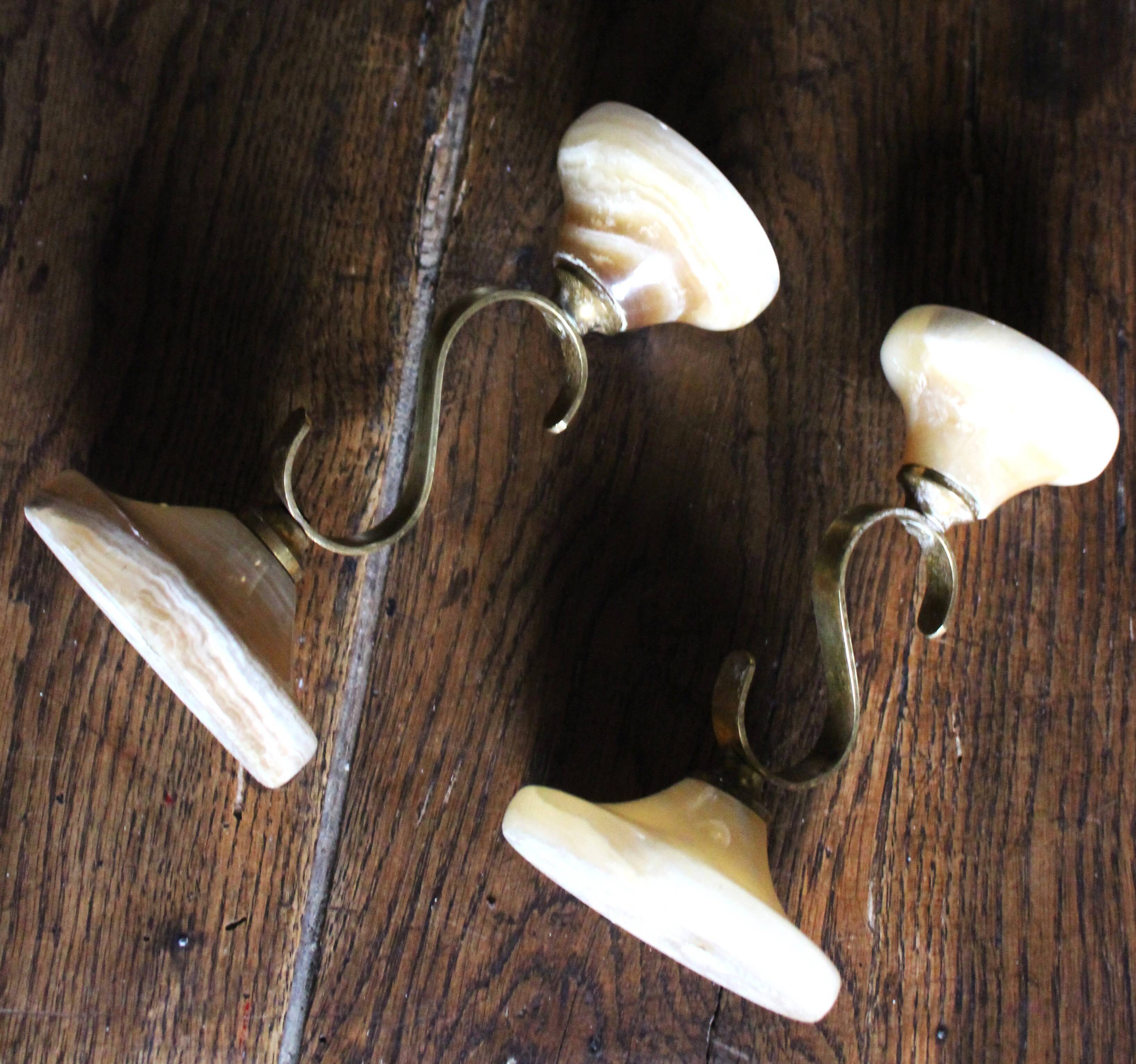 Pair of curved brass candlesticks with onyx