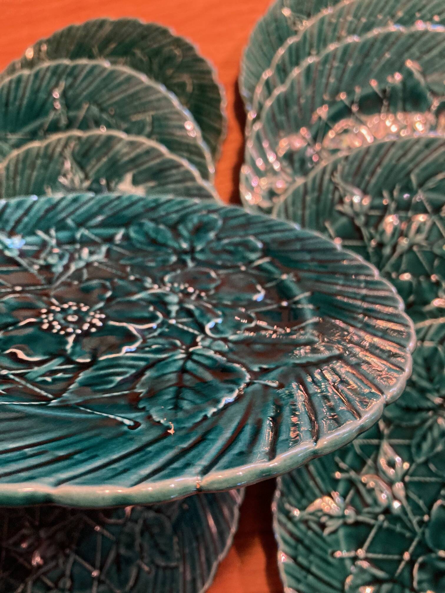 Set of 10 green earthenware dessert plates with a finely embossed floral pattern