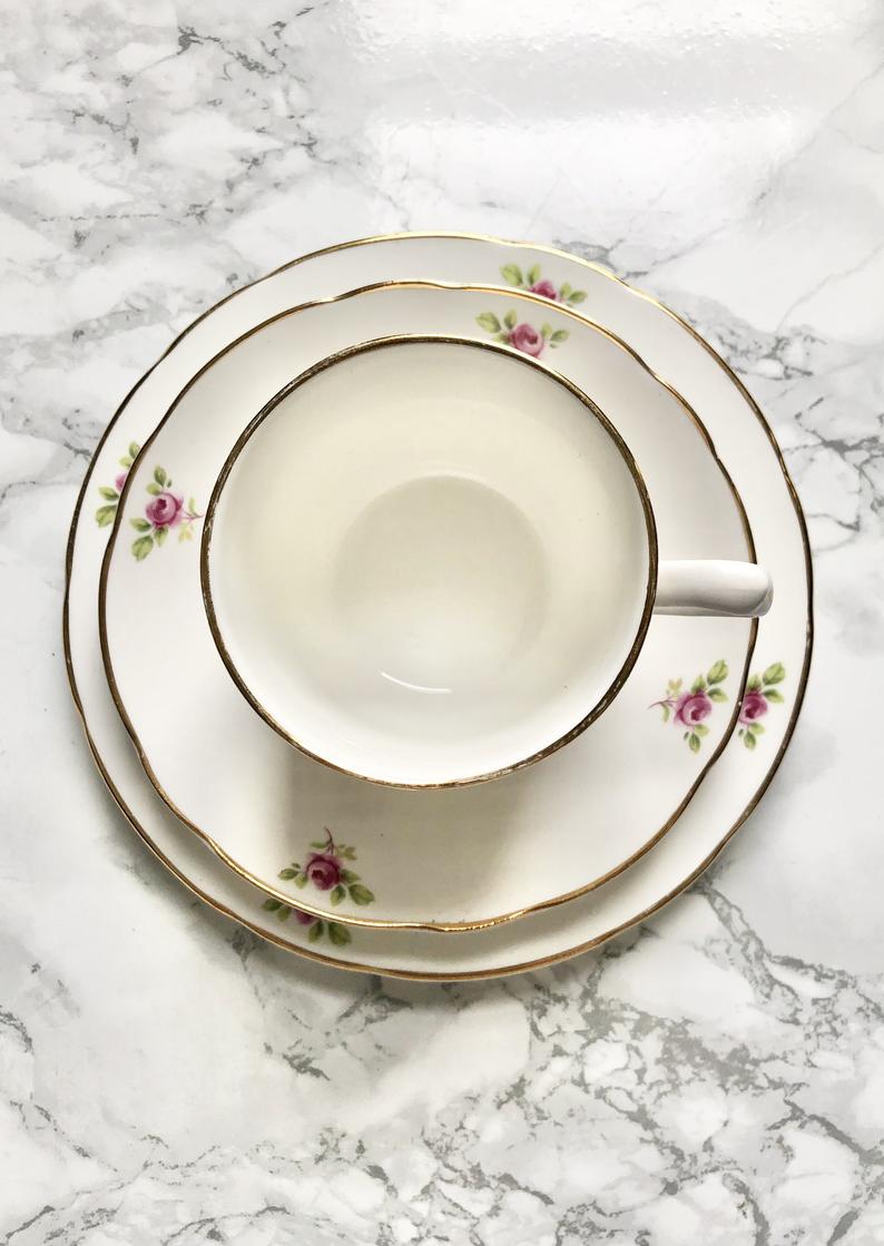 Teacup on its saucer and porcelain cake plate