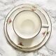 Teacup on its saucer and porcelain cake plate