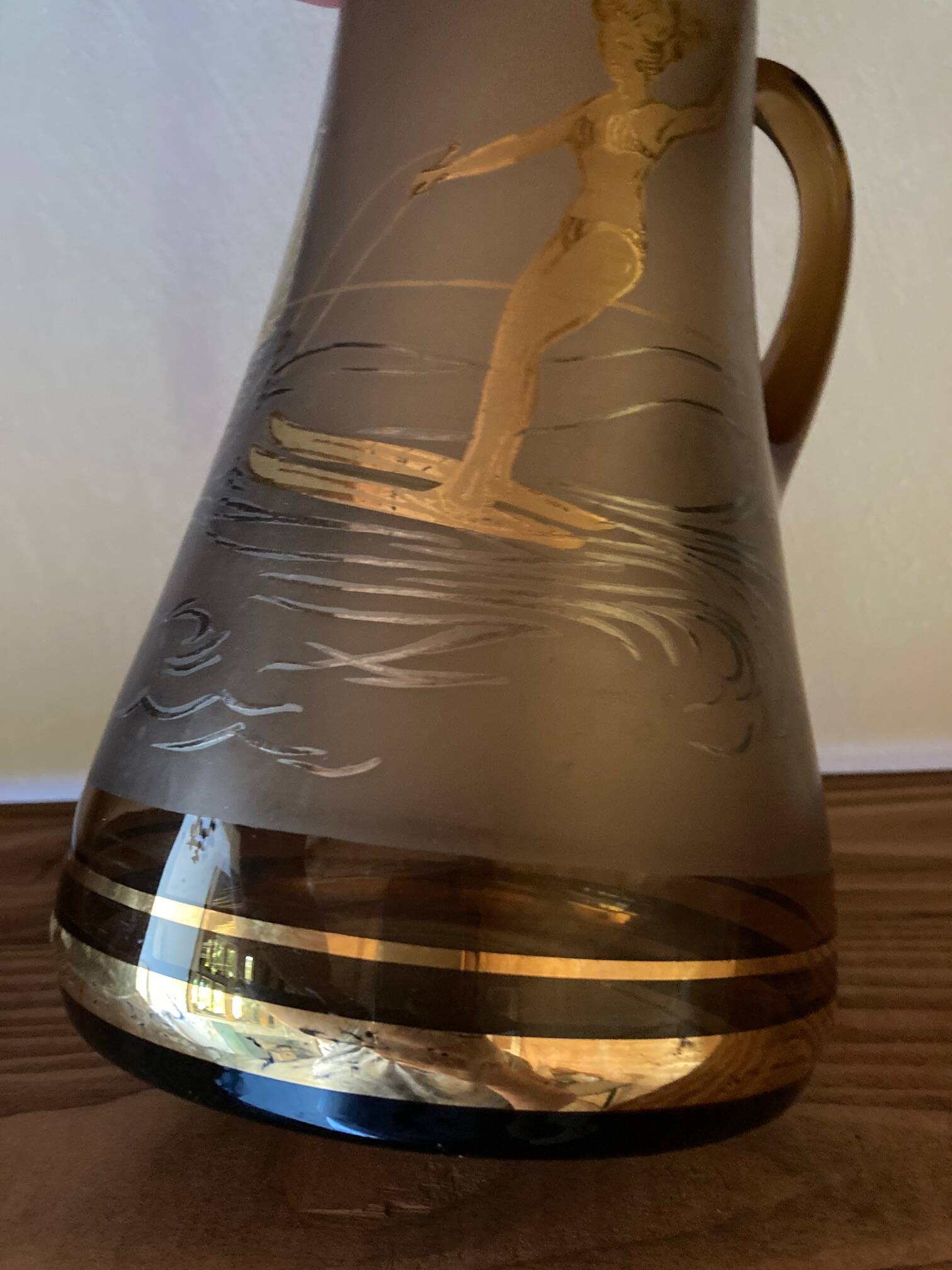 Vintage smoked glass carafe with gold from the 50s/60s, featuring a marine and water skiing design.