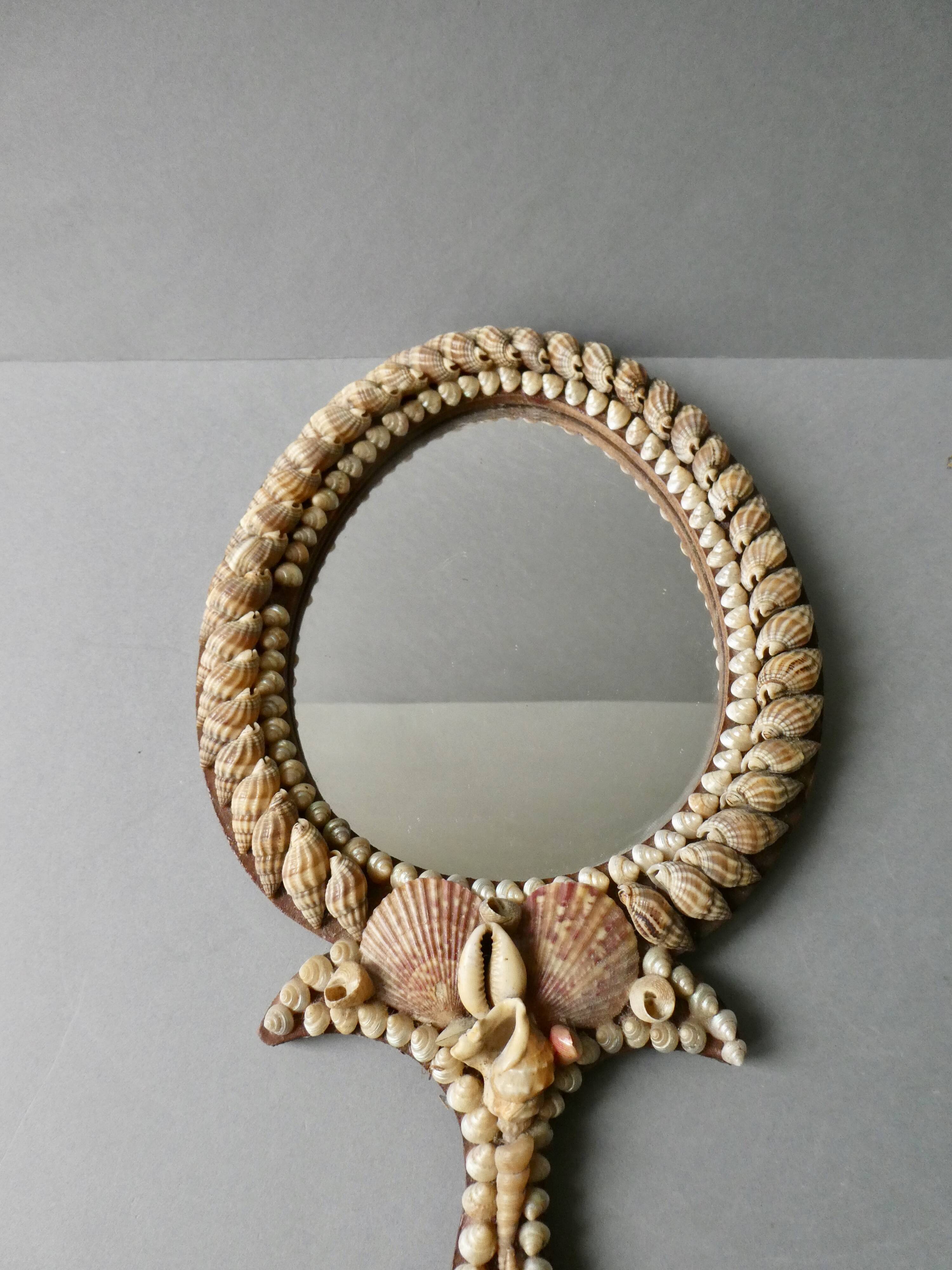 Wall mirror, hand facing in wood and shells