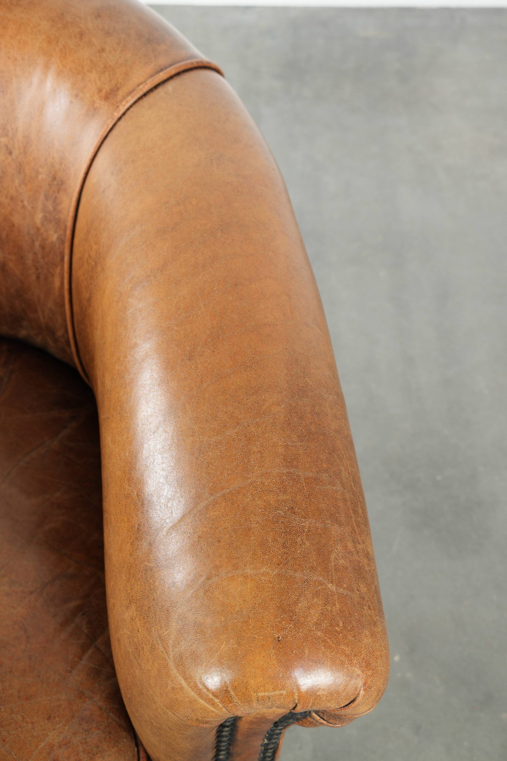 Vintage sheepskin club armchair in a subtle size with warm colours