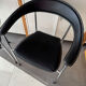 Set of two metal chairs with a brushed finish and black leather.