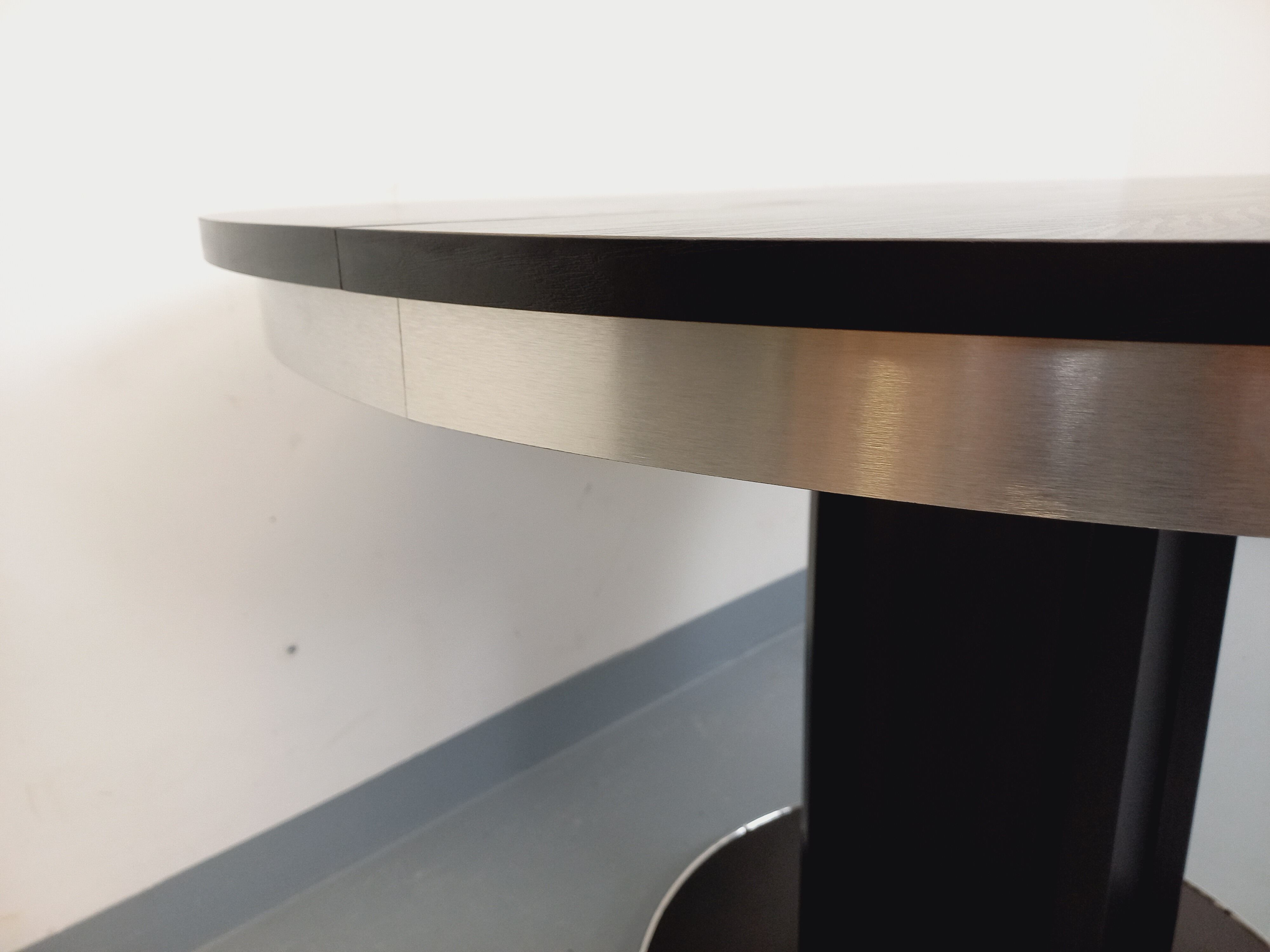 Vintage dining table in melamine with a black wood effect and chrome metal.