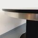 Vintage dining table in melamine with a black wood effect and chrome metal.