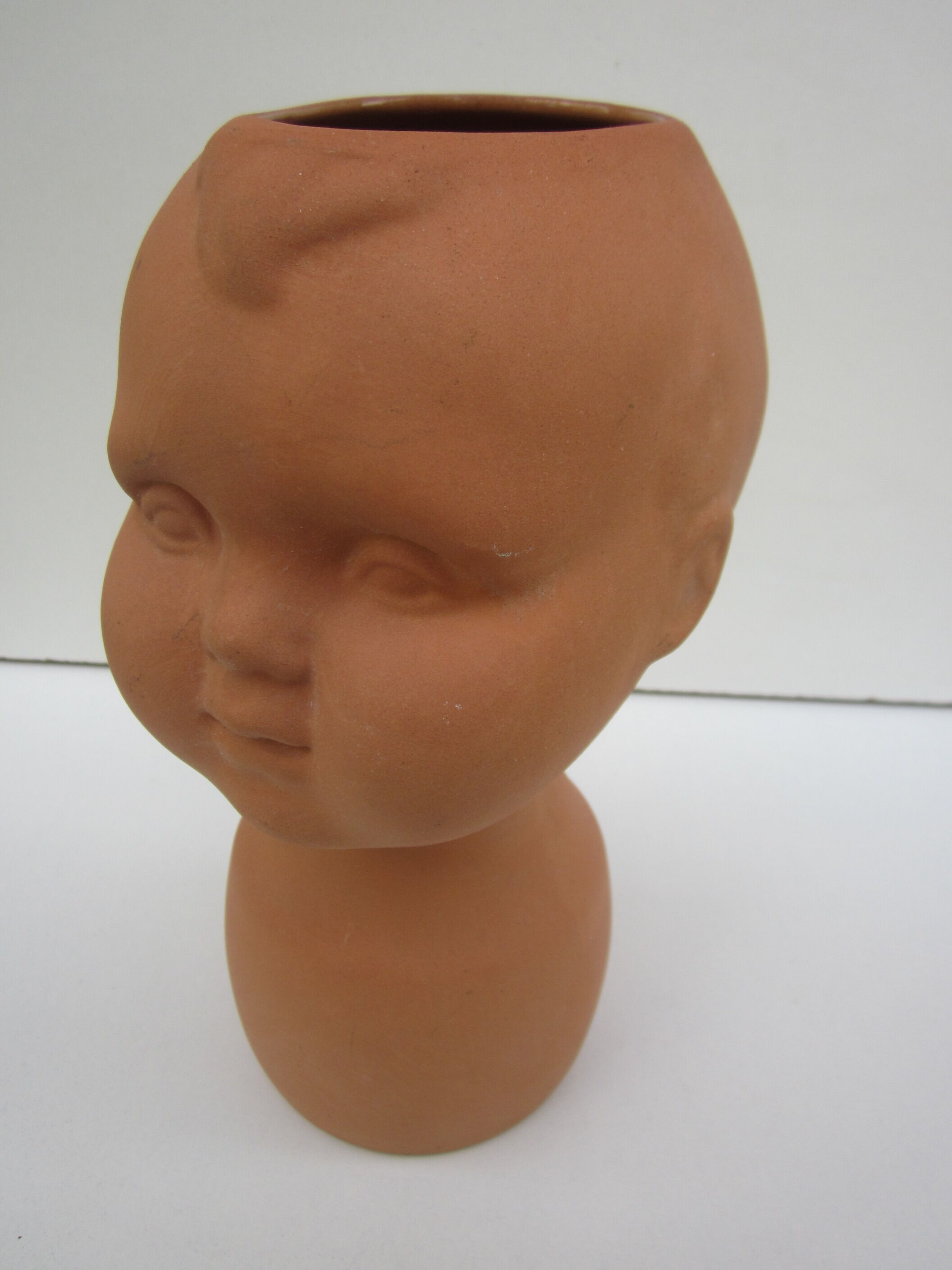 Terracotta vase: child's head