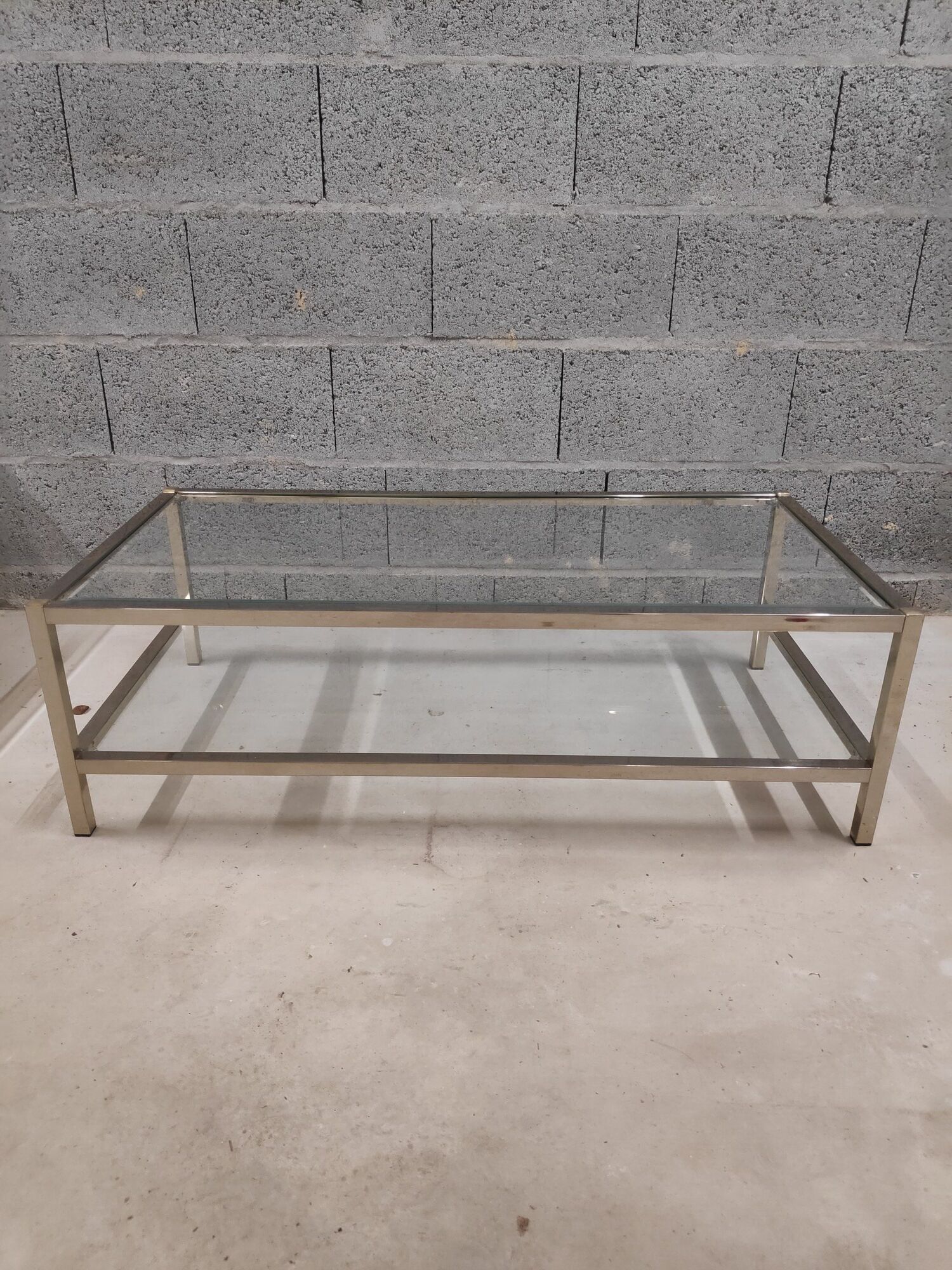 Vintage bevelled glass coffee table and lightly gilded square metal tubes from the 70s/80s