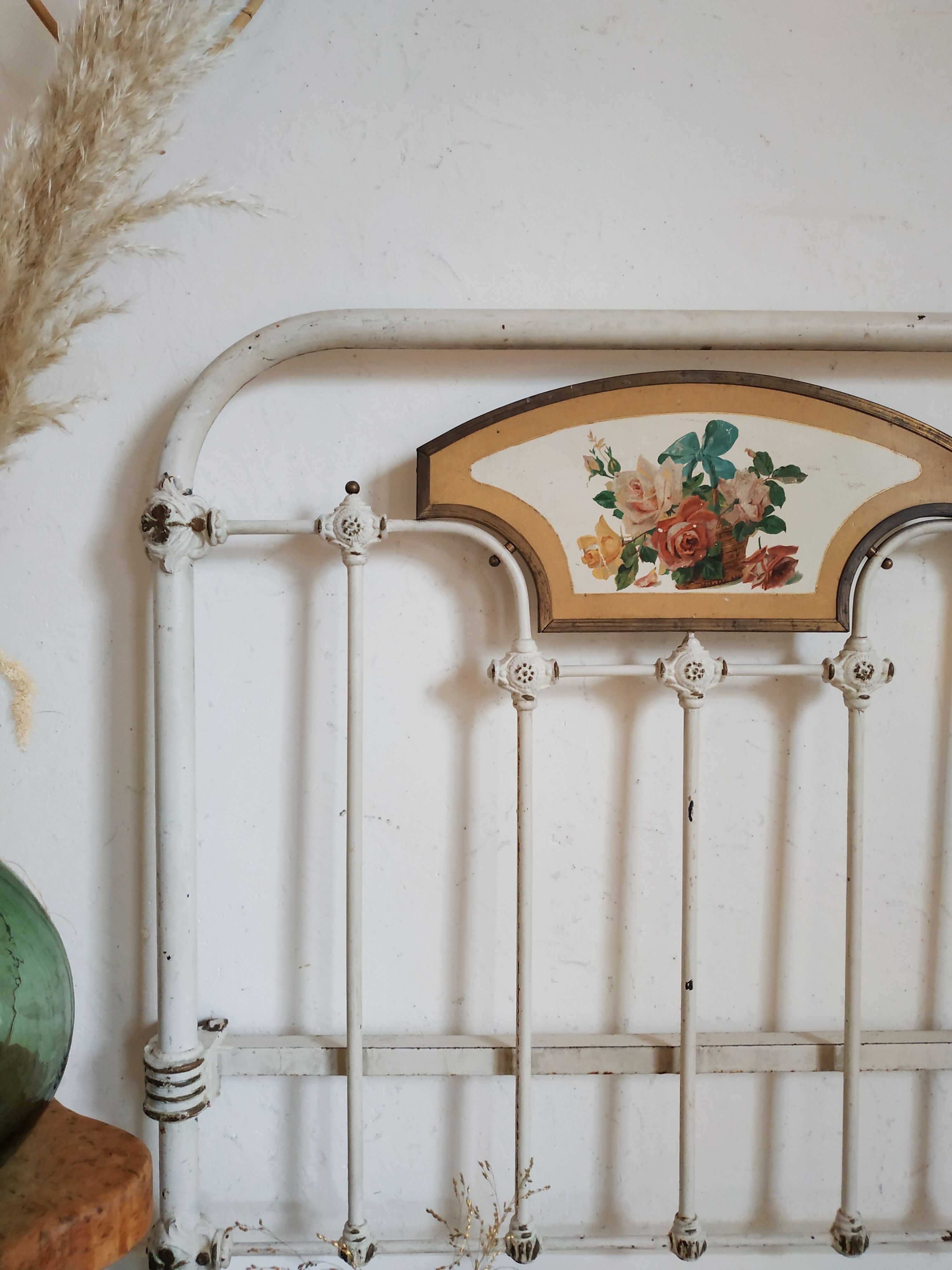 Cast-iron headboard and patinated white wood