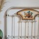 Cast-iron headboard and patinated white wood