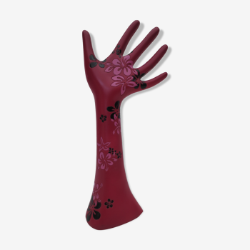 decoration of one hand with raspberry colored forearm dotted with flowers