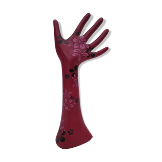 decoration of one hand with raspberry colored forearm dotted with flowers