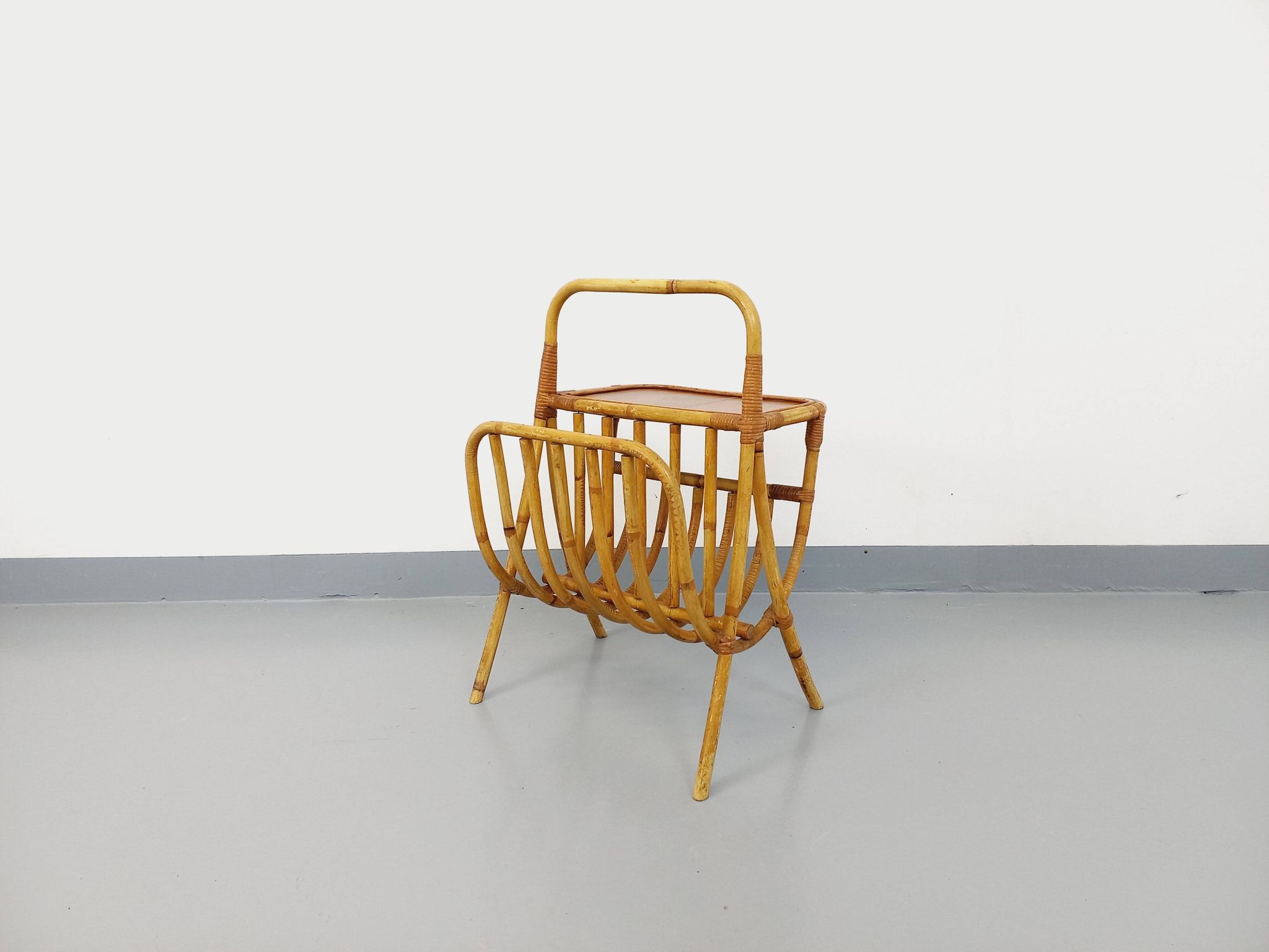 Side table with vintage rattan and wood magazine rack from the 60s