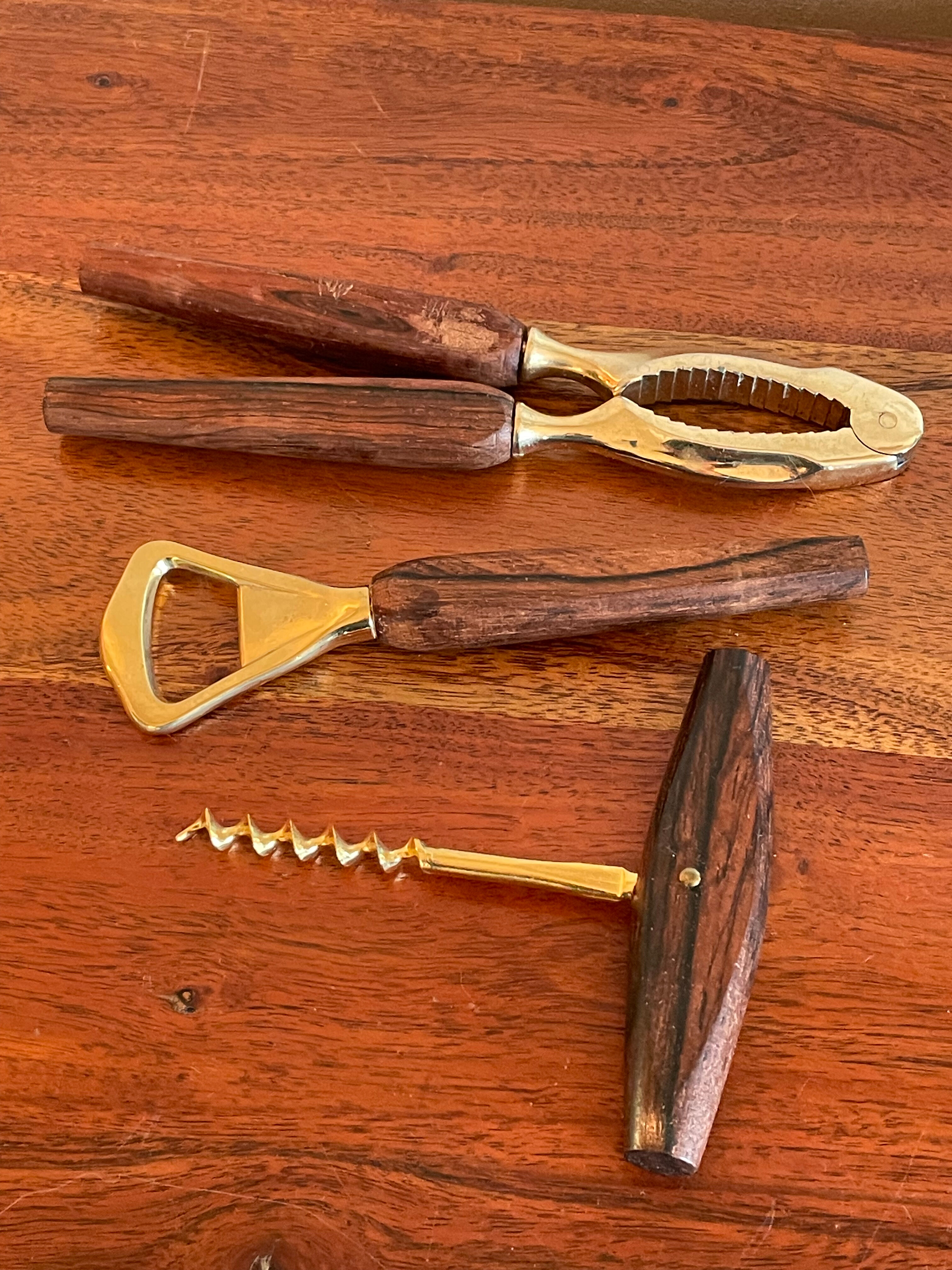 Bottle opener made of teak wood, corkscrew and nutcracker