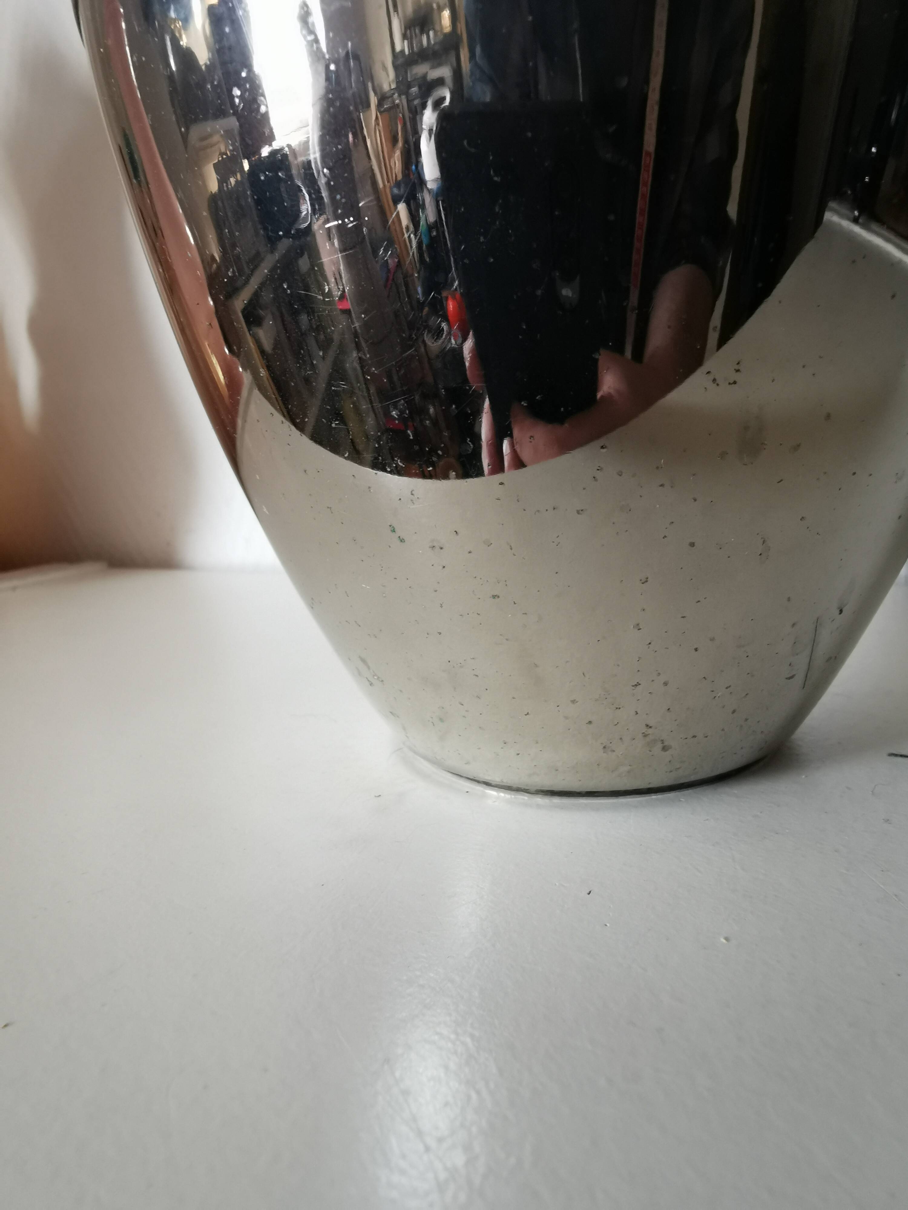 metal vase, flowers in relief