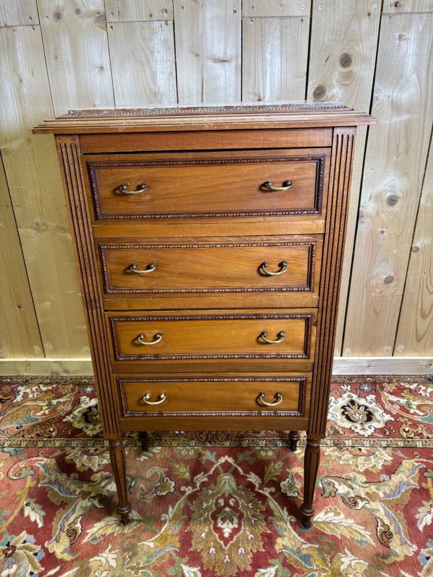 Louis XVI style molded and carved walnut chest of drawers
