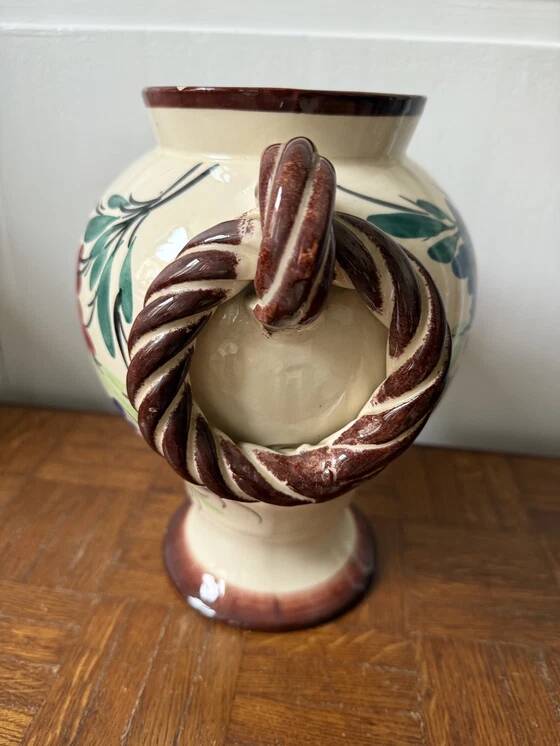 Ceramic vase with hand-painted floral decoration.