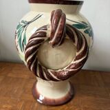 Ceramic vase with hand-painted floral decoration.