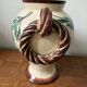 Ceramic vase with hand-painted floral decoration.