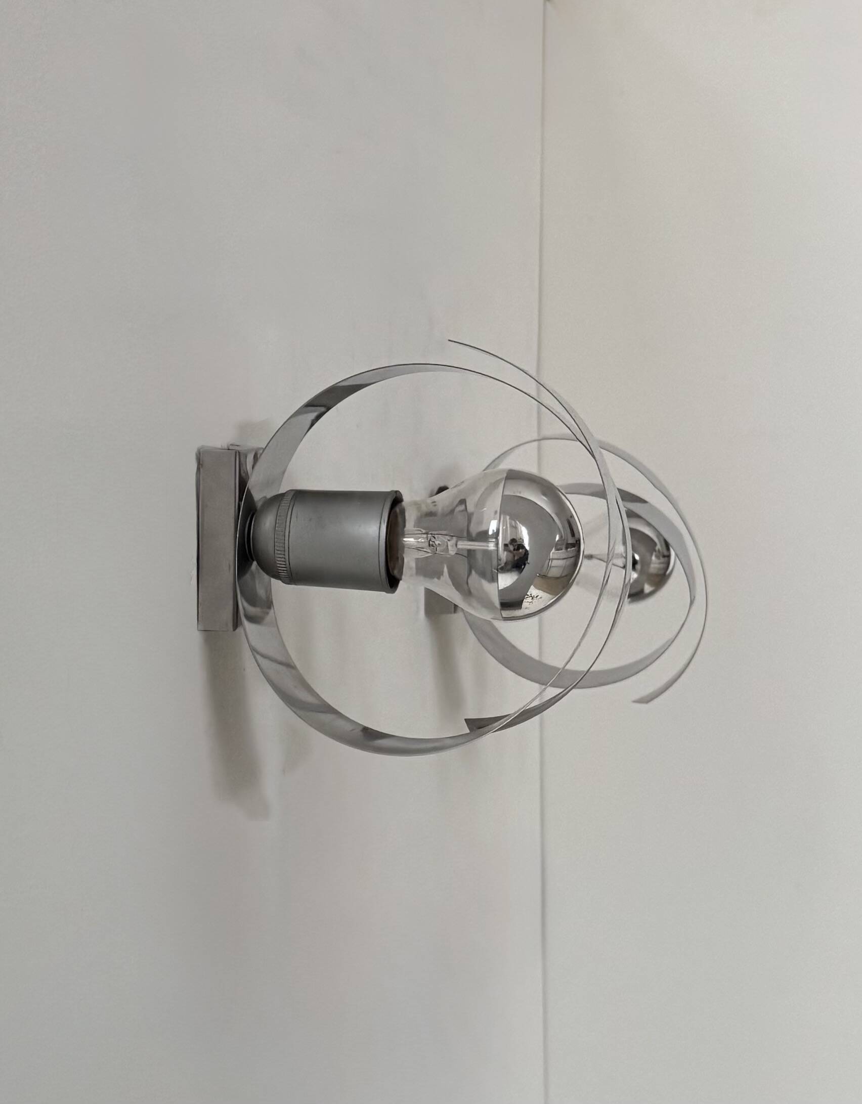 Pair of vintage wall sconces, curved chrome-plated metal, France, 1970