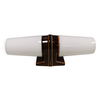 Old bathroom lamp with brown/golden ceramic base, porcelain socket and milky white glass