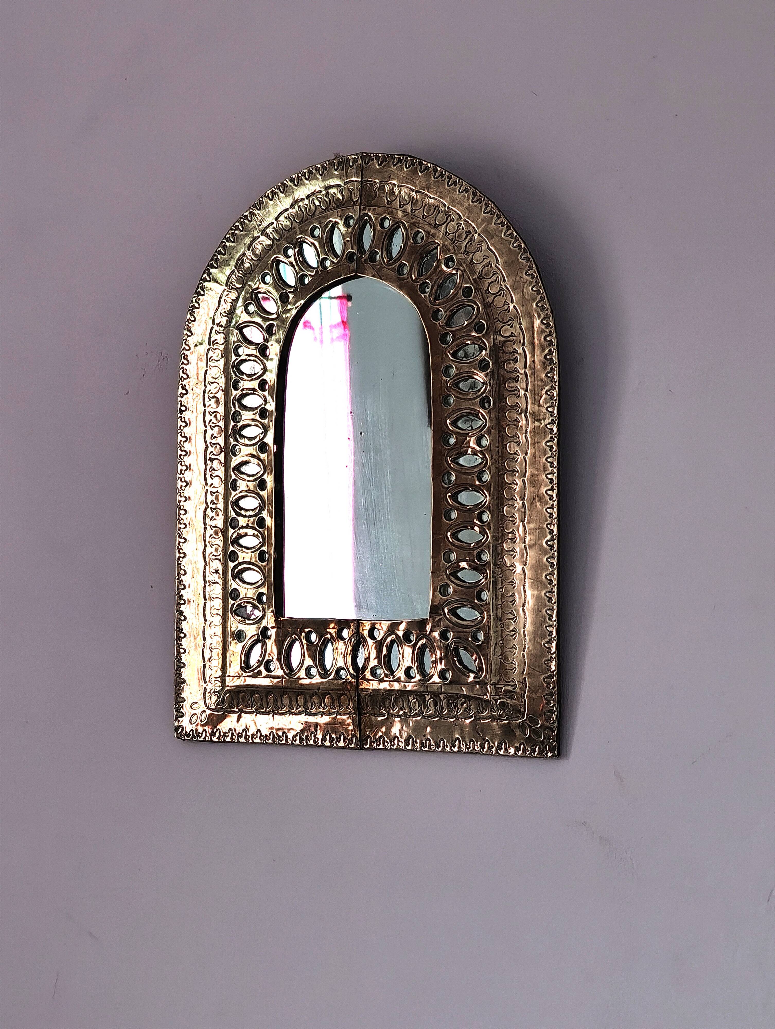 Small golden metal mirror in oriental style.