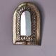 Small golden metal mirror in oriental style.