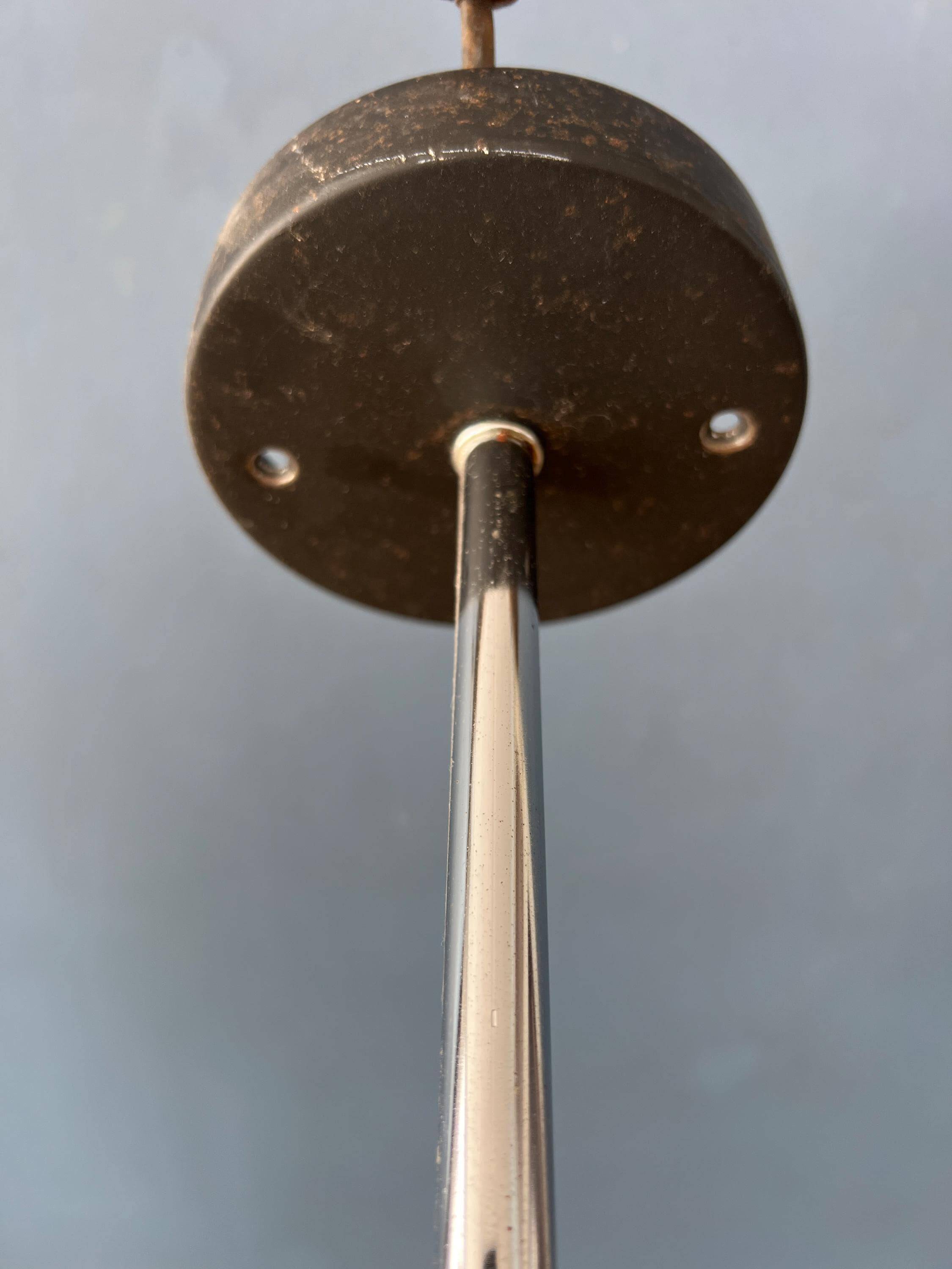 Vintage pendant light with three green spots.