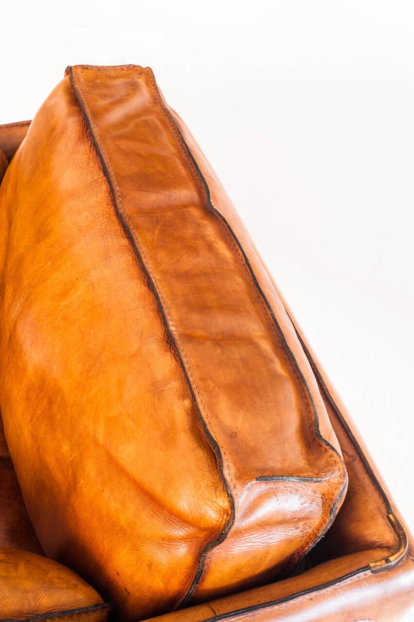 Vintage club armchair by Roche Bobois. Camel buffalo leather. France, 1980s.