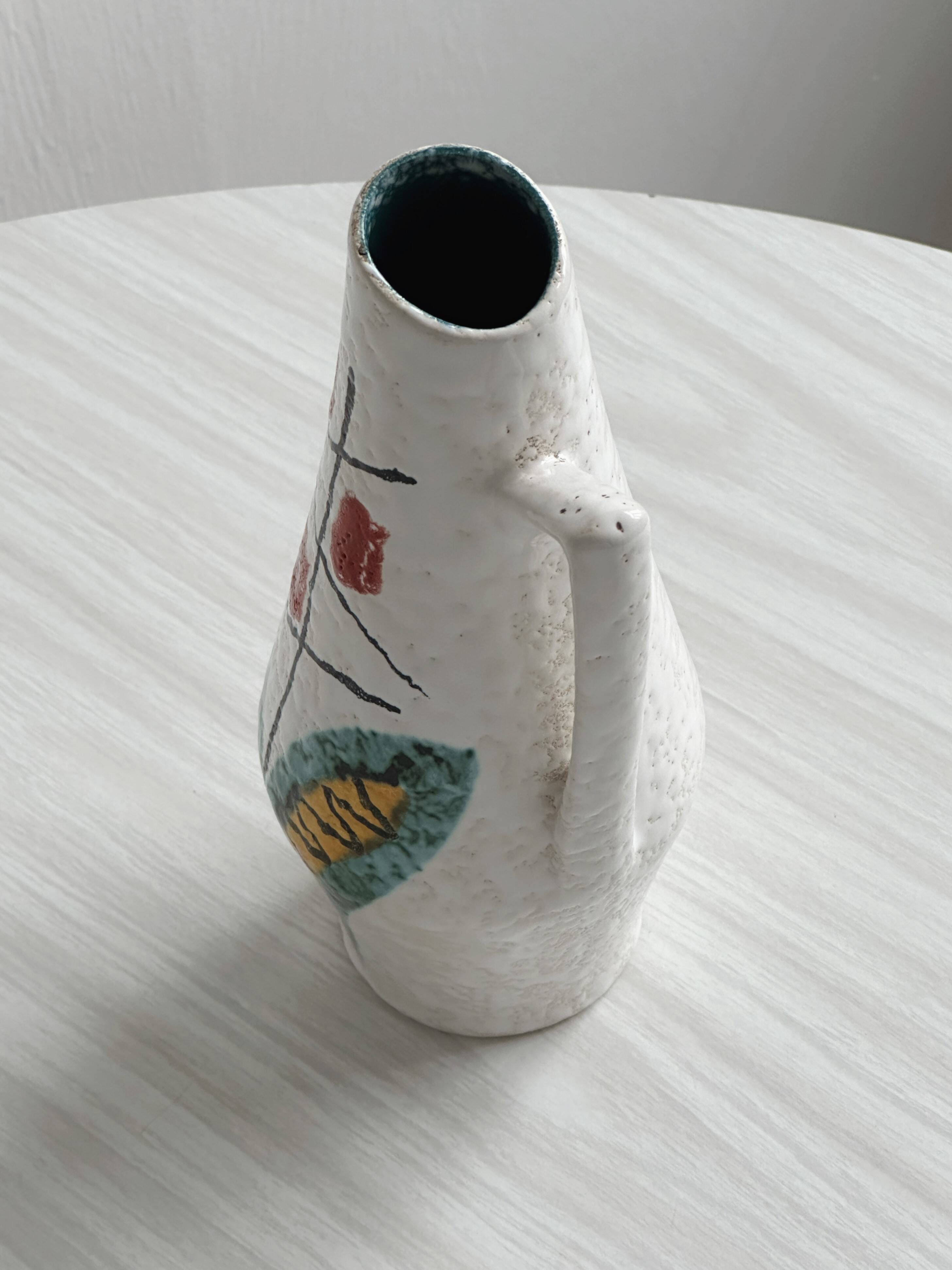 Ceramic pitcher with hand painted floral pattern
