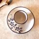 Glazed ceramic shell with painted floral decoration