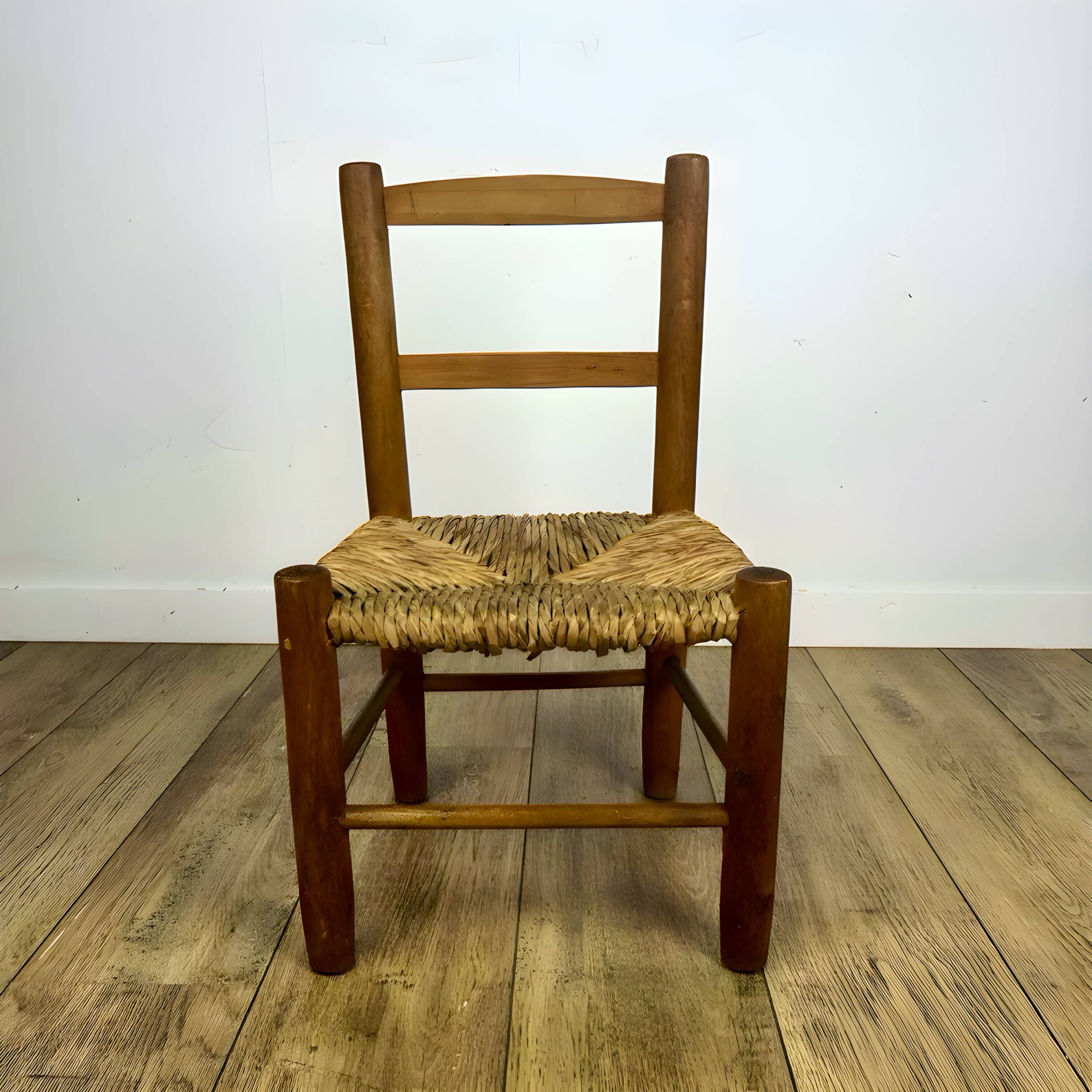 Pair of old wooden and straw children's chairs.