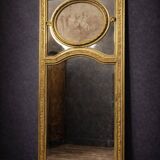 Very large mirror with mouldings, richly carved and gilded, in the Louis XVI style.