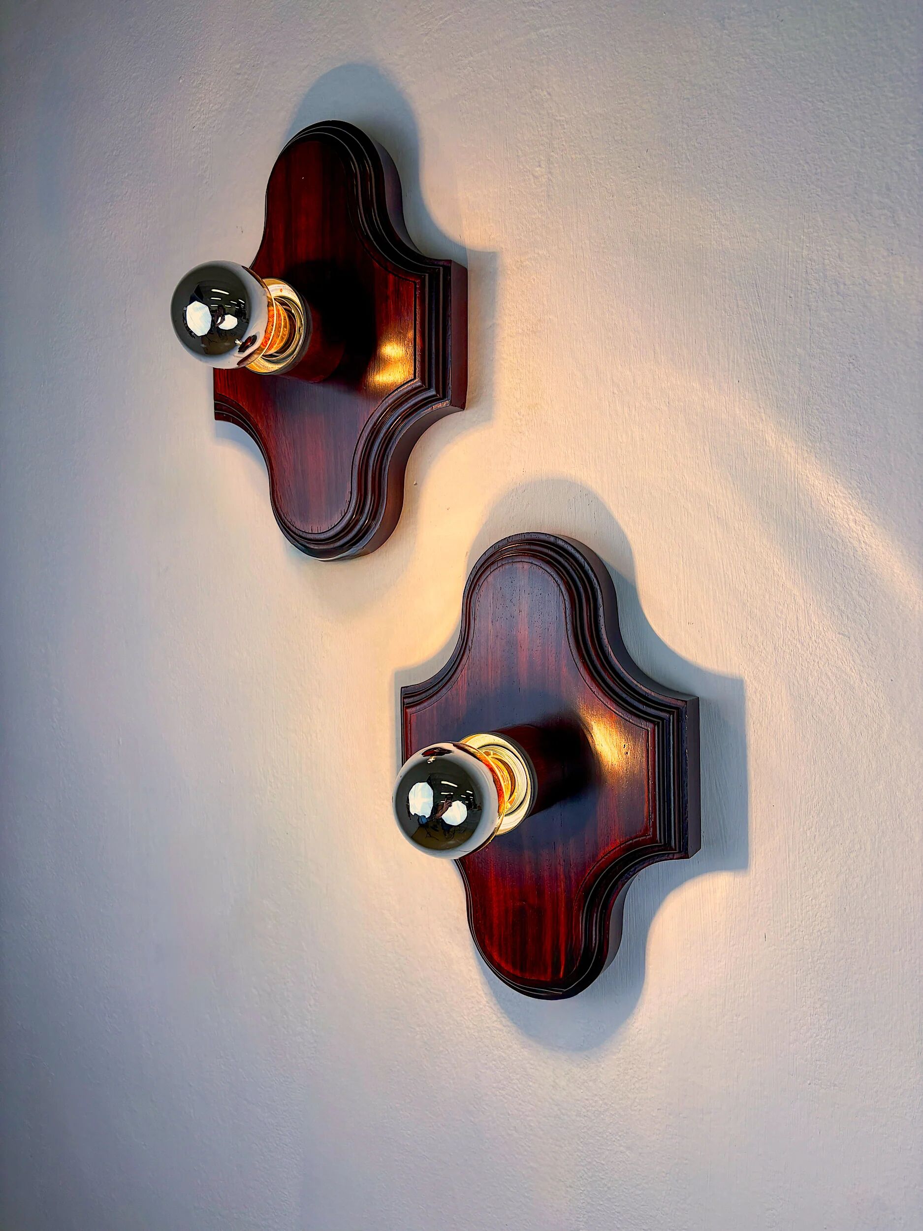 Pair of geometric Art Deco wall lights, carved wood, France, 1960s