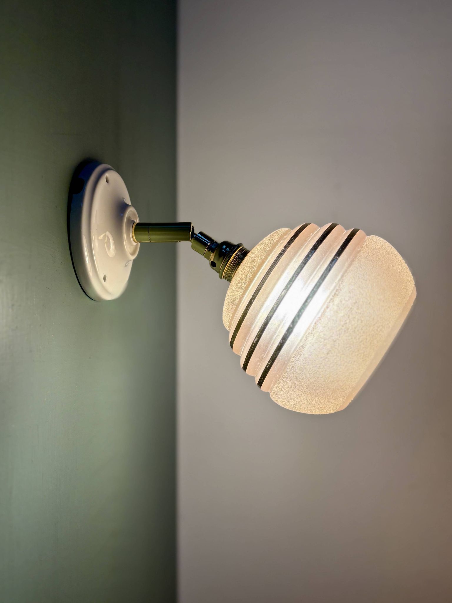 Vintage globe wall light in frosted pink and gold glass.