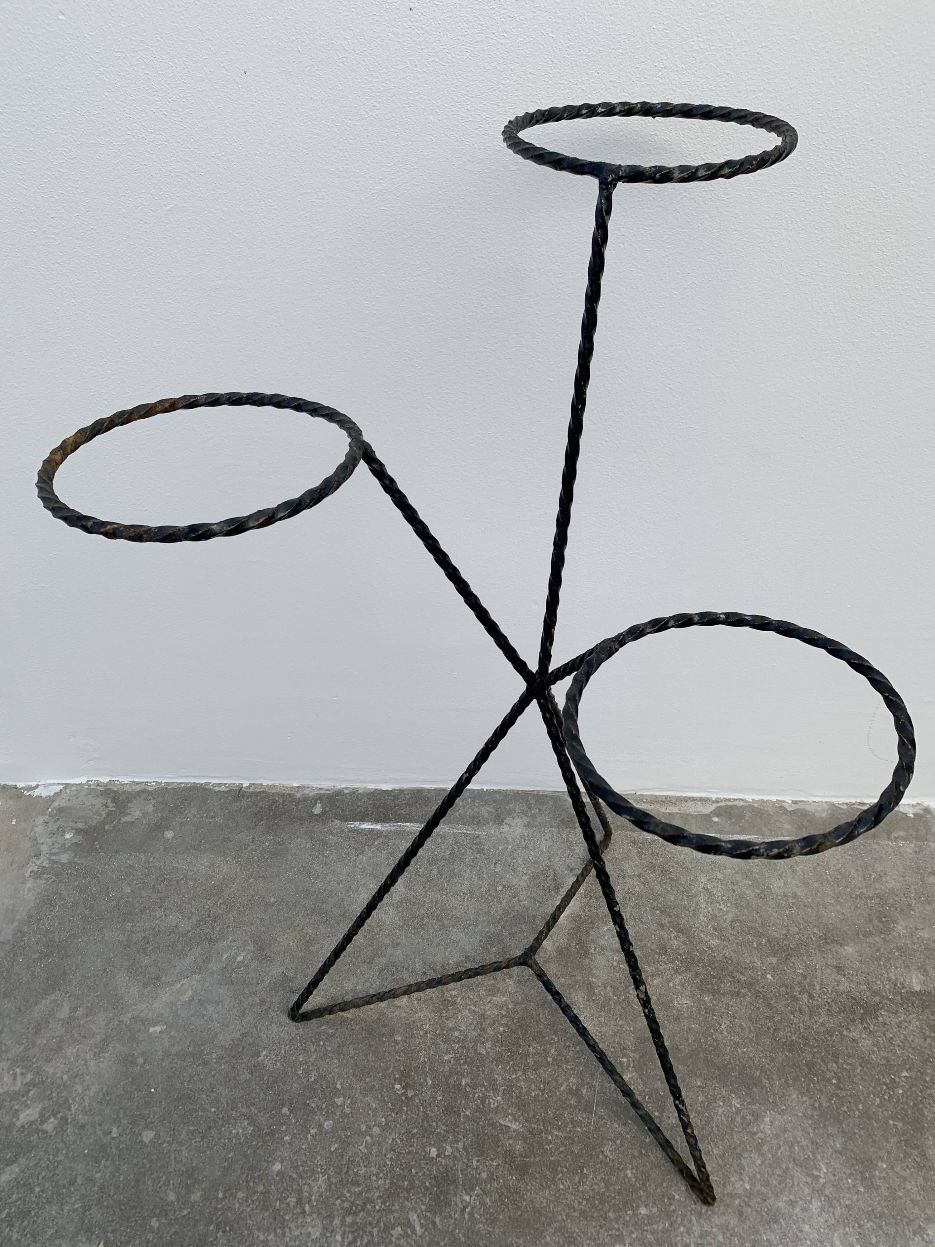 Black metal tripod plant holder