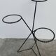 Black metal tripod plant holder