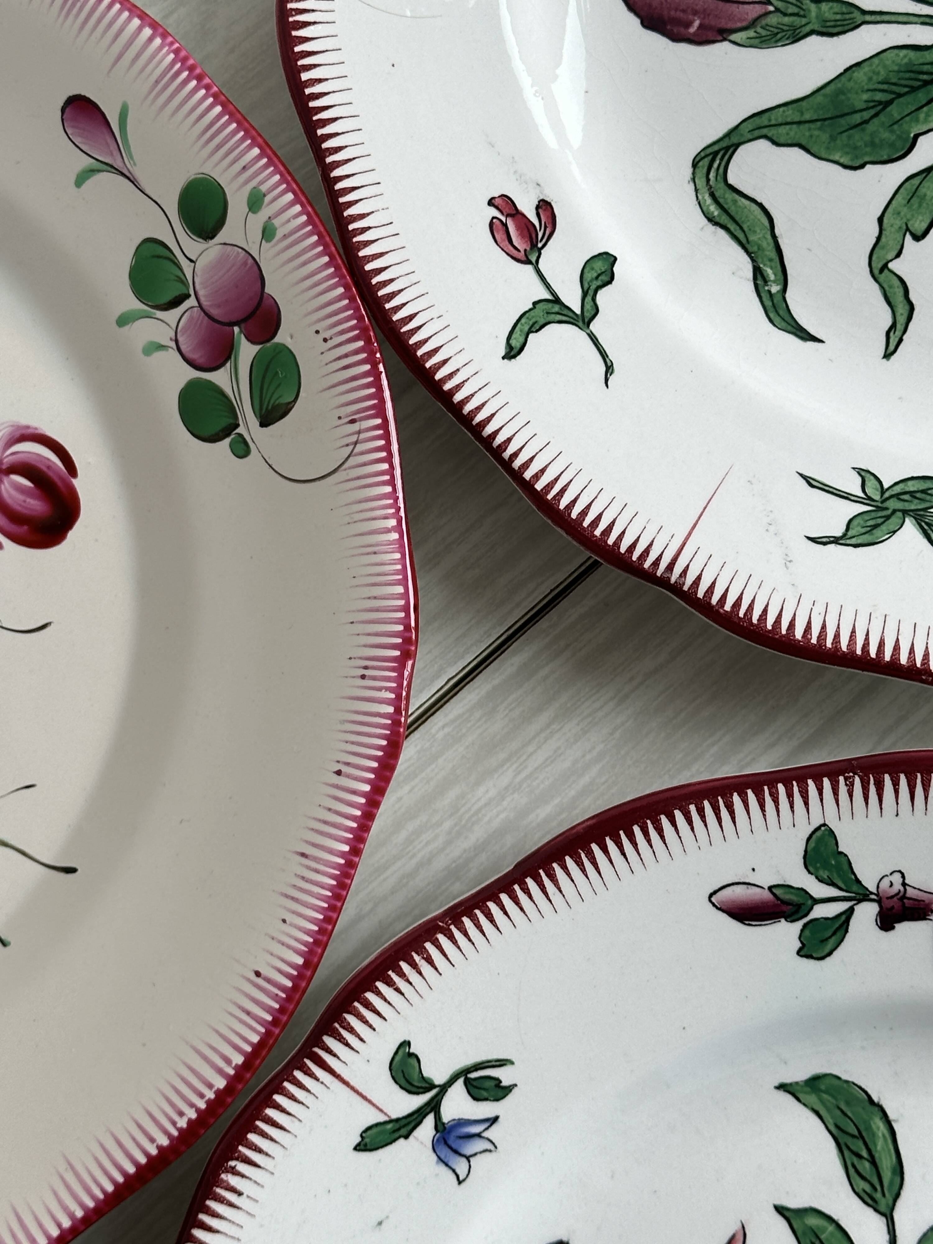 5 plates with colorful Sarreguemines floral designs.