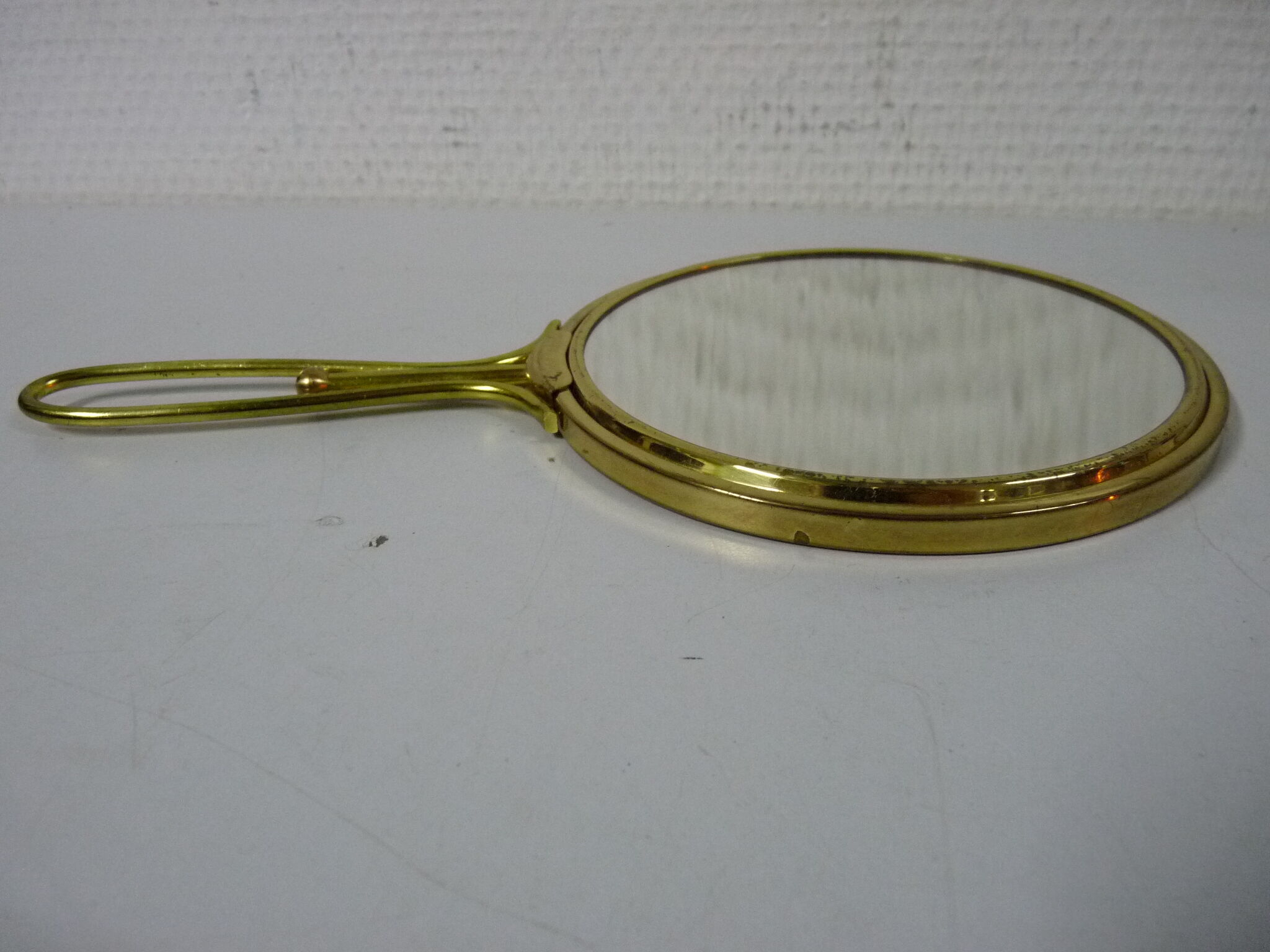 Old mirror double face with golden hand