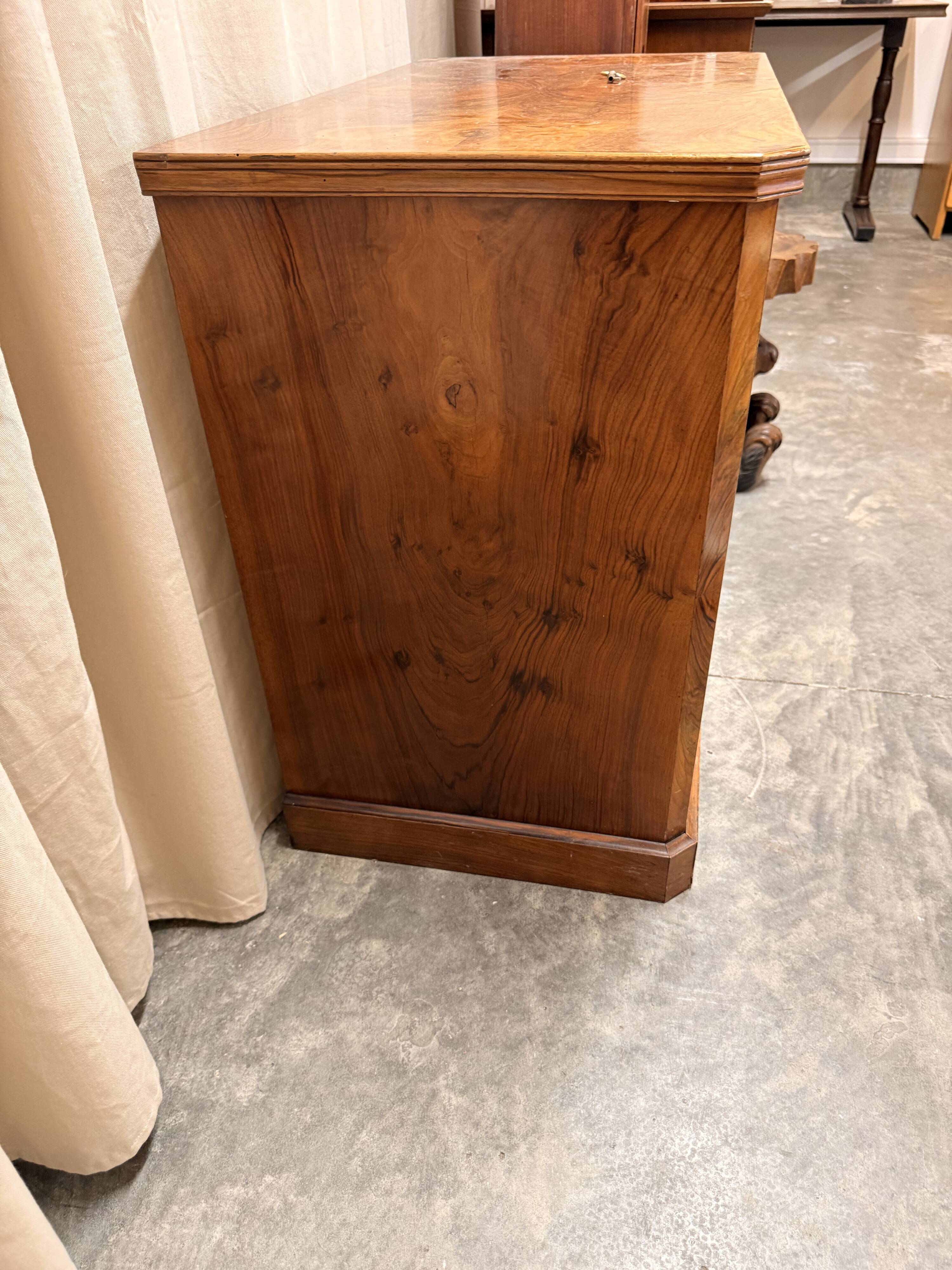 Antique English commode in flame walnut.