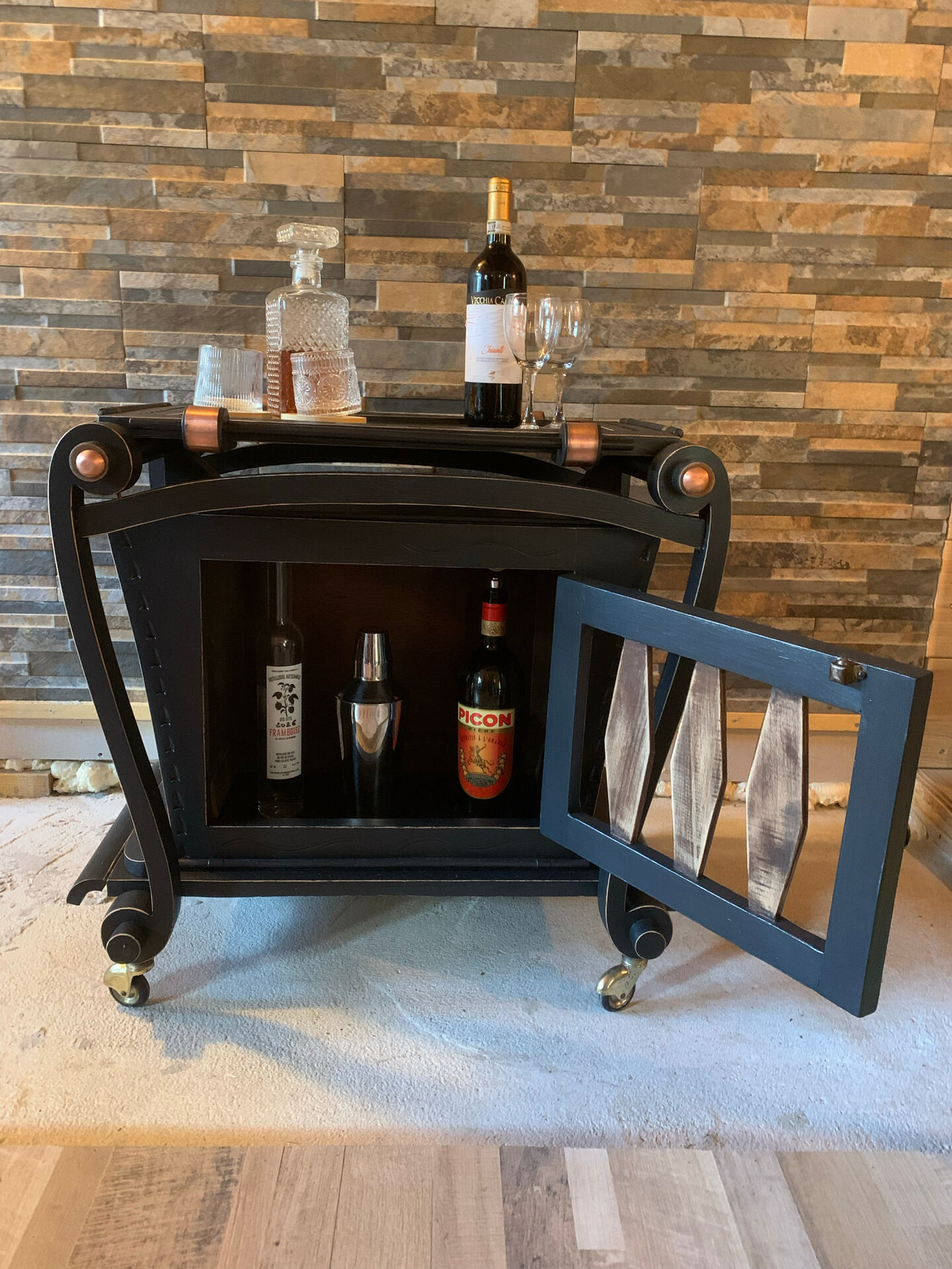 Renovated vintage bar cart in black and copper with removable serving tray.