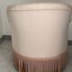 Pink armchair with patterns and fringes.