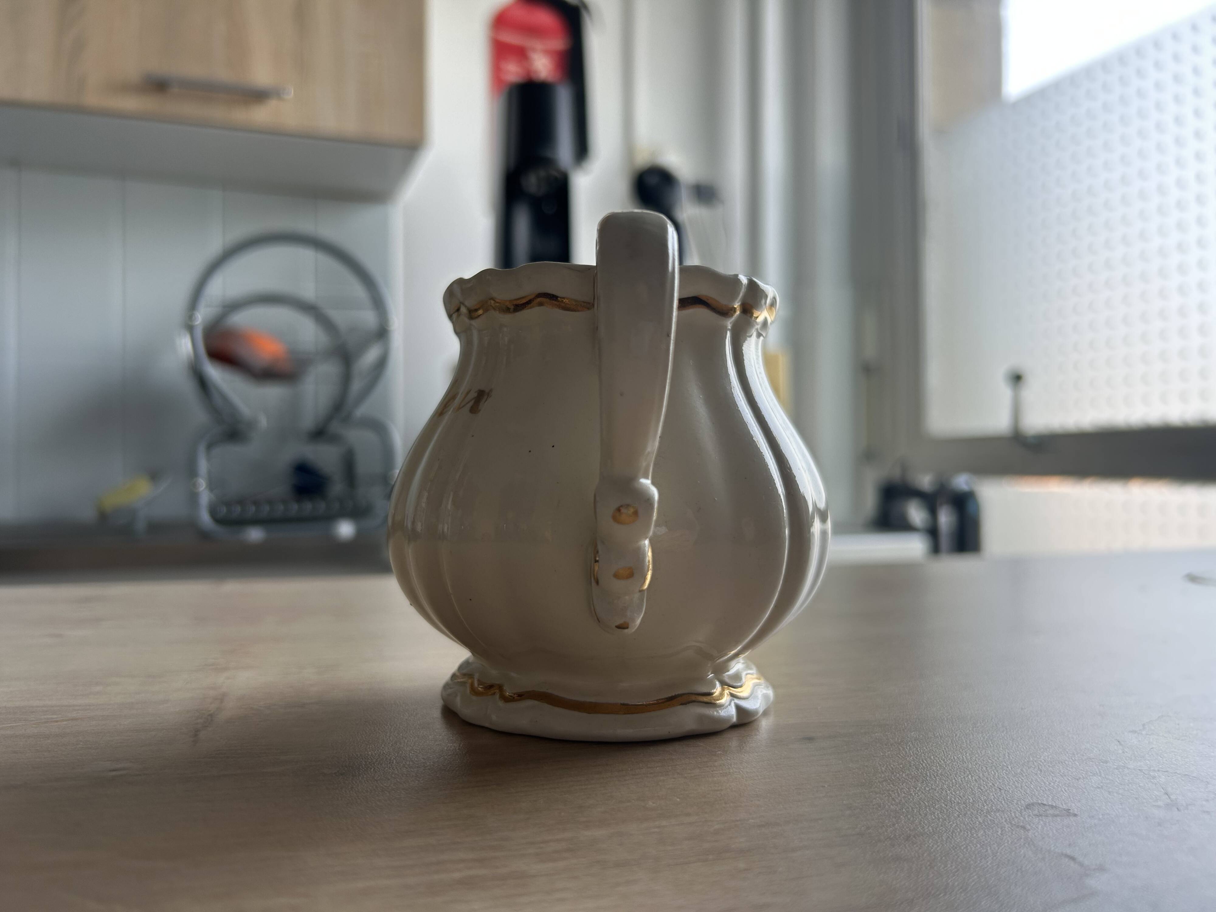 Old cream jug "Nous deux" in Sarreguemines earthenware.