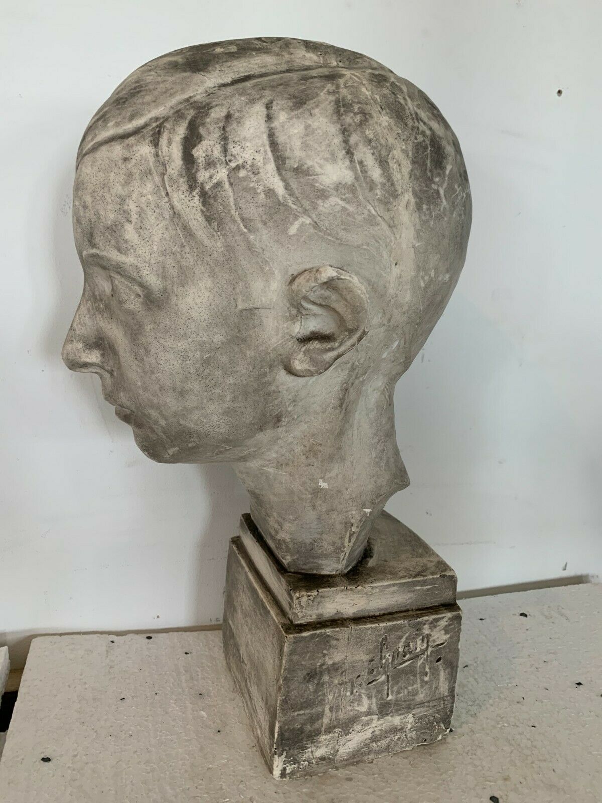 Bust of a young man in plaster signed Gerard Choain XX century
