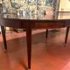 Directoire period extendable dining table in mahogany with a band.